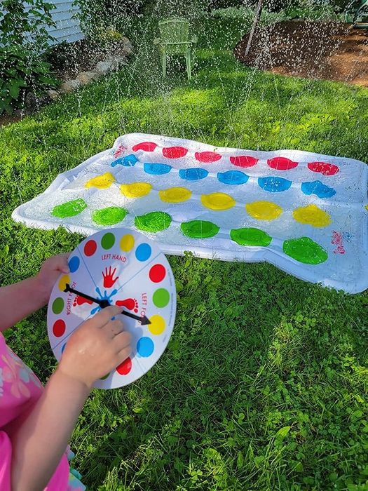 A reviewer's photo featuring the spinner and sprinkler mat from Twister Splash