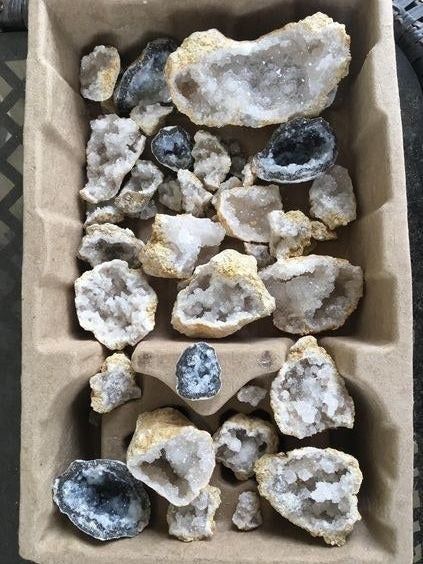 A reviewer's collection of opened geodes showcasing their sparkling interiors