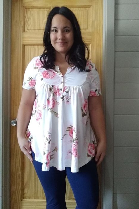 Reviewer styling the tunic in a pink floral print