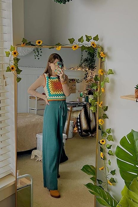 A reviewer shares a photo of themselves wearing teal sweater pants.