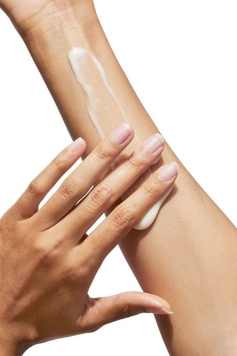 A hand applying lotion