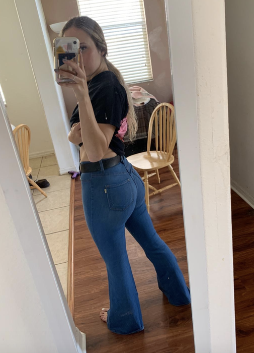 A reviewer shows off the back of their denim jeans.