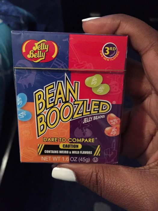 A reviewer posing with the box of jelly beans