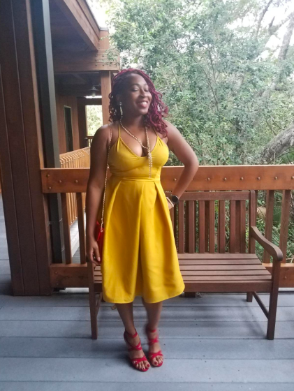 A reviewer showcasing the dress in a vibrant yellow hue.