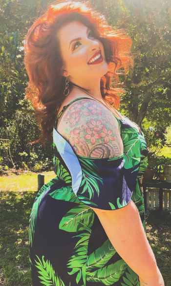 Reviewer showcasing the side view of the cold-shoulder sleeve