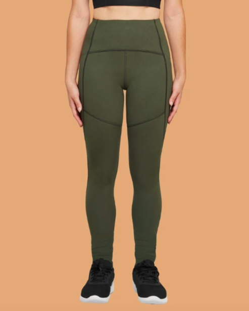 A model is wearing the Thinx leggings in green.