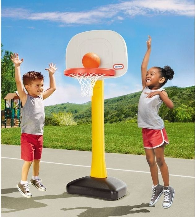 Children enjoying their time with the basketball hoop