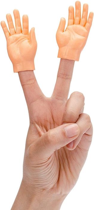 model making a peace sign with two tiny plastic hands on their fingers