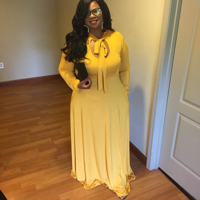 Reviewer in the long-sleeve version of the dress, now in a bright yellow hue.