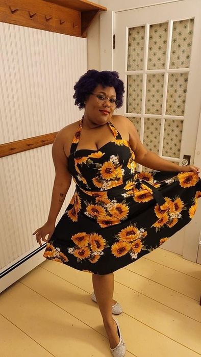 The dress in black adorned with a sunflower print.