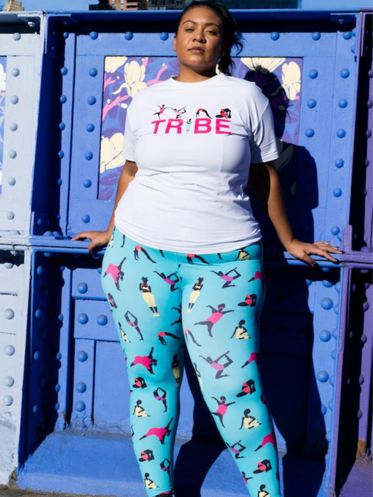 A plus-size model sports blue leggings with black prints of models exercising on them.