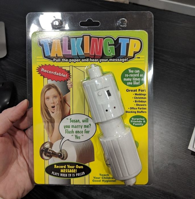 Reviewer holding the toilet paper holder in its packaging
