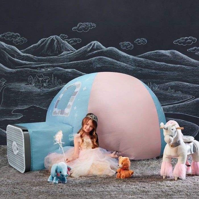 A child plays next to an inflated tent