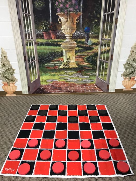 A reviewer's photo showing the game mat being used for checkers