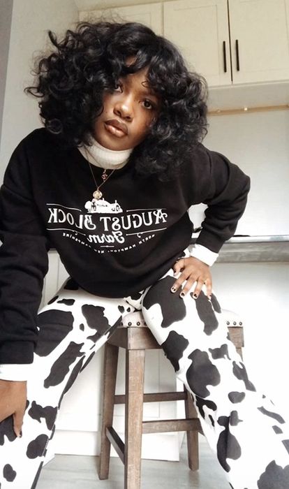 A reviewer rocking the cow print wide-leg jeans.