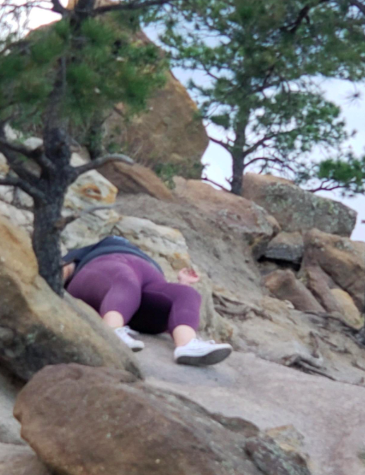 A customer review photo showing them sliding down a hill while wearing the leggings.