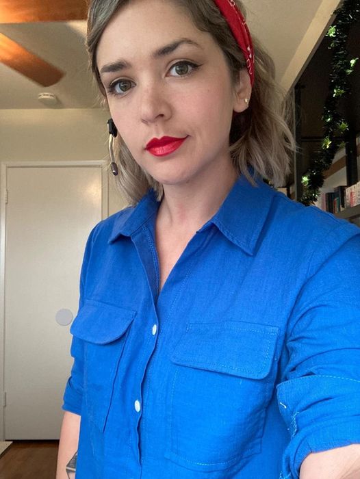 Customer modeling the shirt in blue