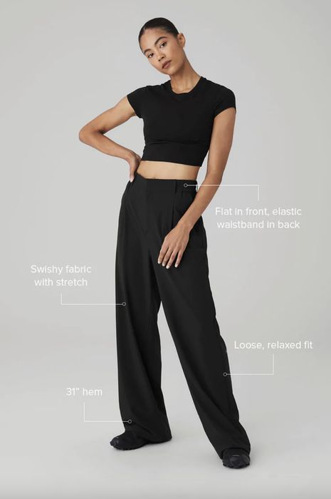 A woman models a black crop top and wide-leg pants with detailed descriptions of the fit and design.