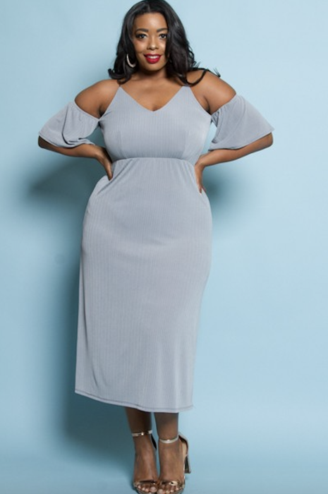 A model in a soft pale blue midi dress with cut-out sleeves.