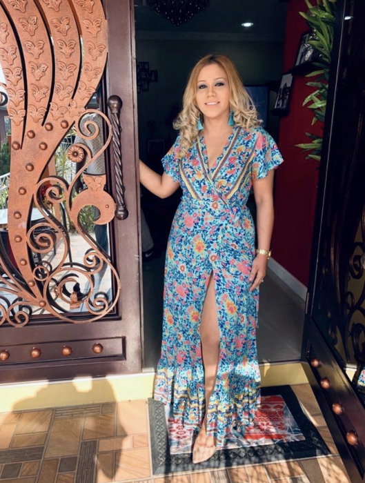A reviewer wearing the dress in a teal shade