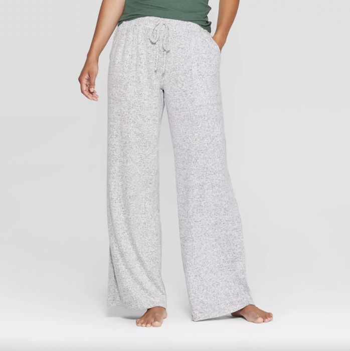 A person rocks gray speckled lounge pants with a drawstring and a cozy green top.