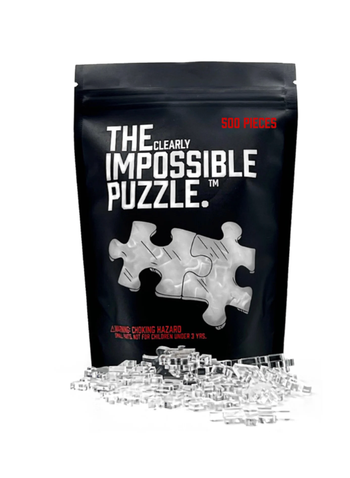 The box with some of the clear puzzle pieces laid out in front
