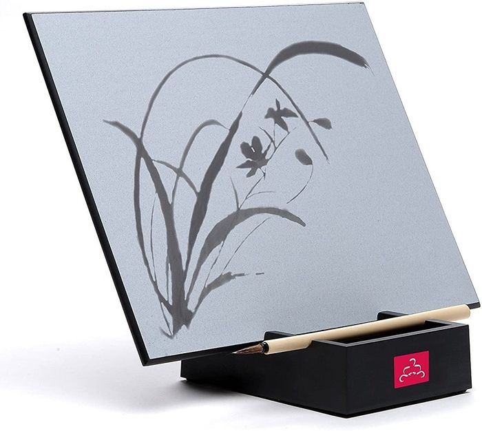 A gray board on a black base featuring floral artwork