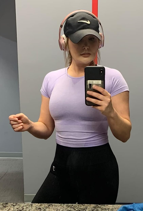 a reviewer sporting the crop top in light purple