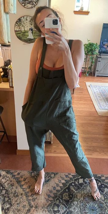 a reviewer wearing the army green version of the overalls