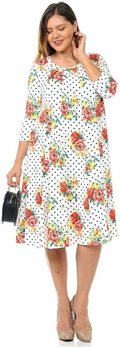 plus-size model in a white dress with black polka dots and a rose pattern