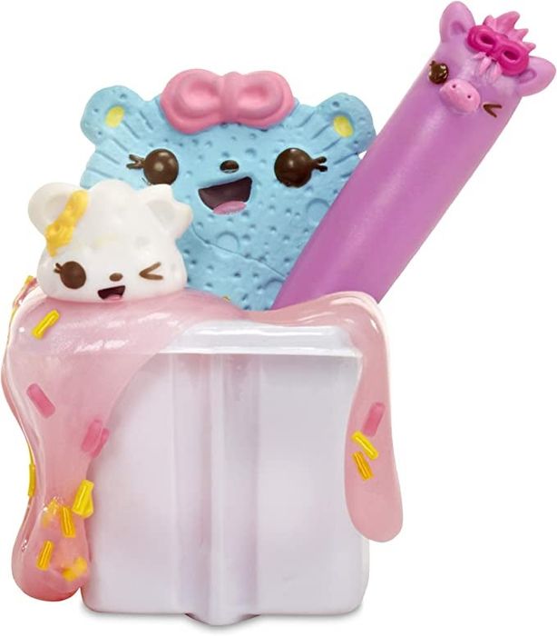 Three toys dipped in a container with slime spilling over the edges