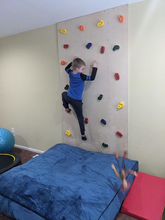 A reviewer's photo showing their child climbing the rock wall