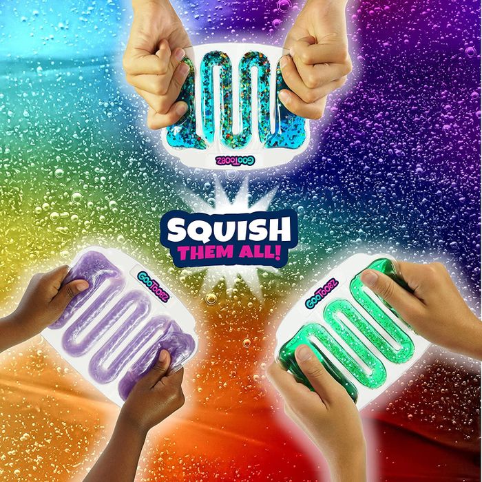 Hands interacting with three different colorful squishy toys