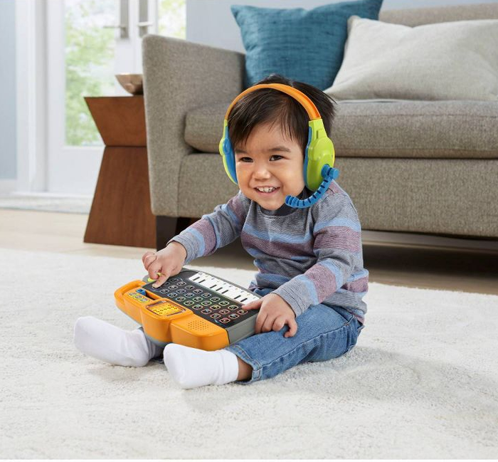 a child enjoying the detachable keyboard and headphones