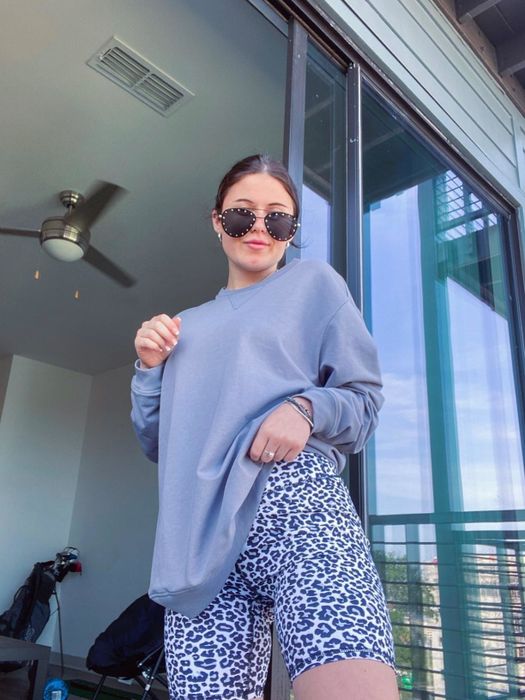 a reviewer showcasing the light blue leopard-print shorts