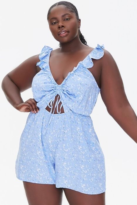 a front view of a model wearing the ruffled blue romper