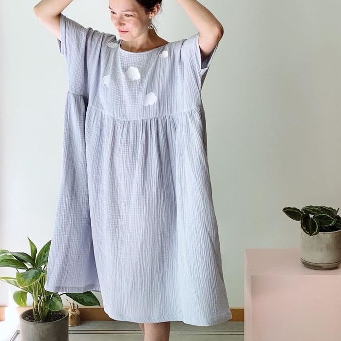 a model showcasing the light blue version of the dress