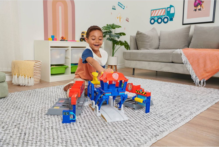 a child enjoying playtime with the Paw Patrol truck stop