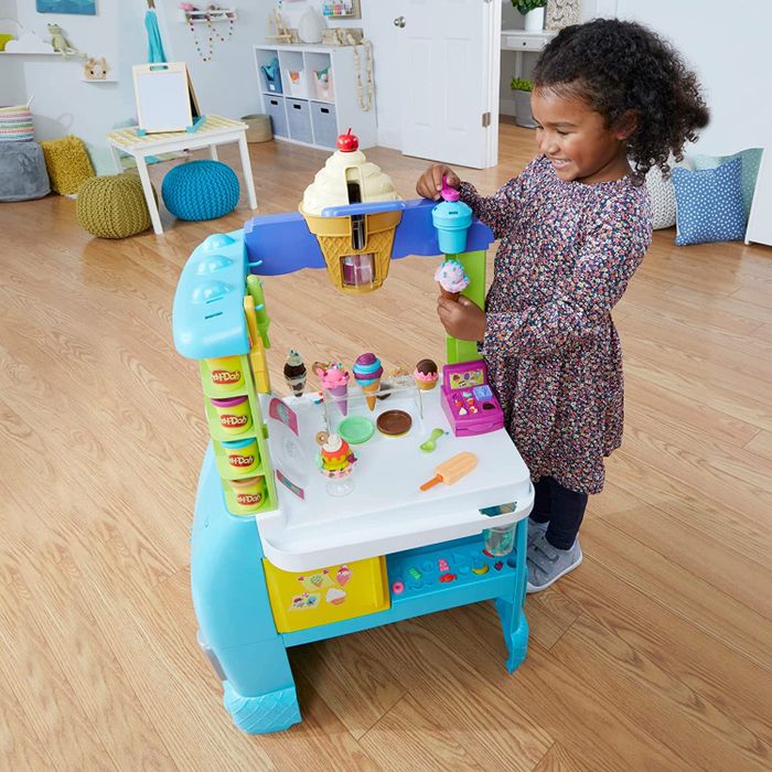 a child enjoying the Play-Doh ice cream truck playset