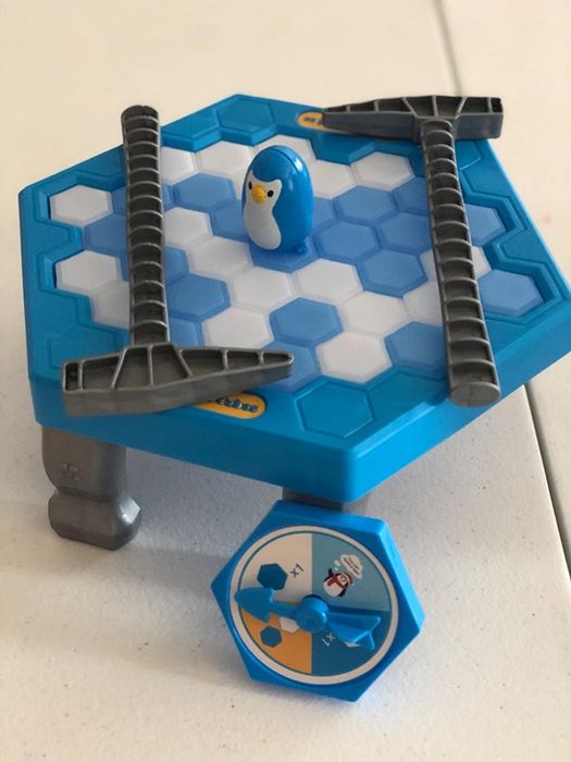 A close-up of the assembled toy featuring the penguin and two toy ice picks on top