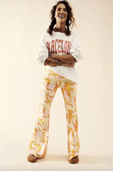 Model wearing yellow flare pants