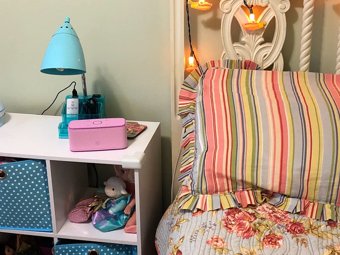 a review photo of the speaker on a nightstand in a child's bedroom