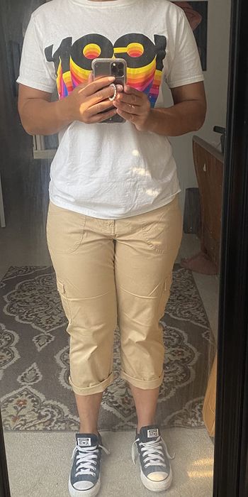 front view of reviewer wearing tan cargo pants with a tee and sneakers