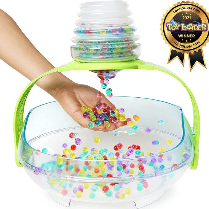 A child enjoying the Orbeez playset and having fun with the colorful beads
