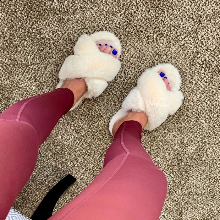 A reviewer is wearing slippers in the color beige.