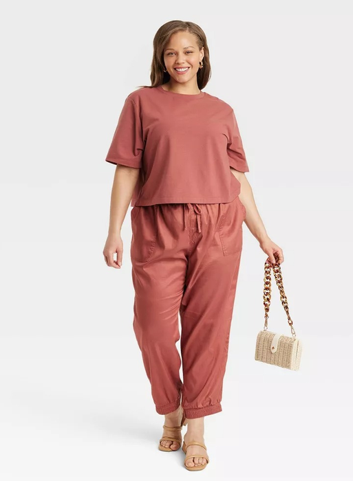 model wearing rust-colored ankle joggers