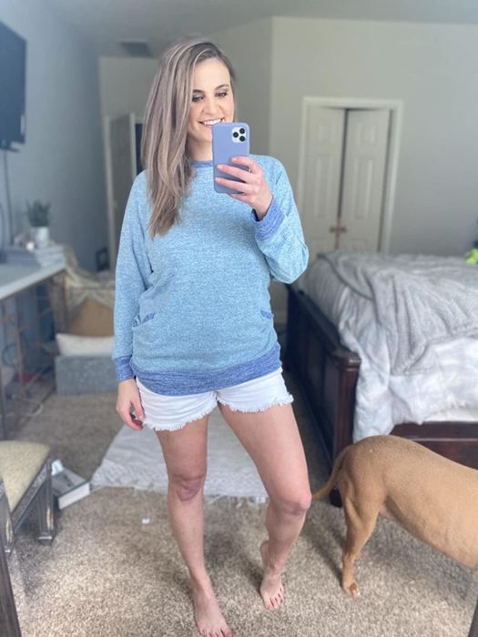 An Amazon reviewer is wearing a gray-blue tunic-style sweater.