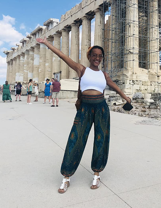 reviewer wearing the green peacock print pants