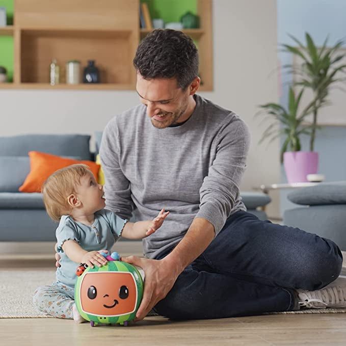 A parent and child playing with the toy together on the floor