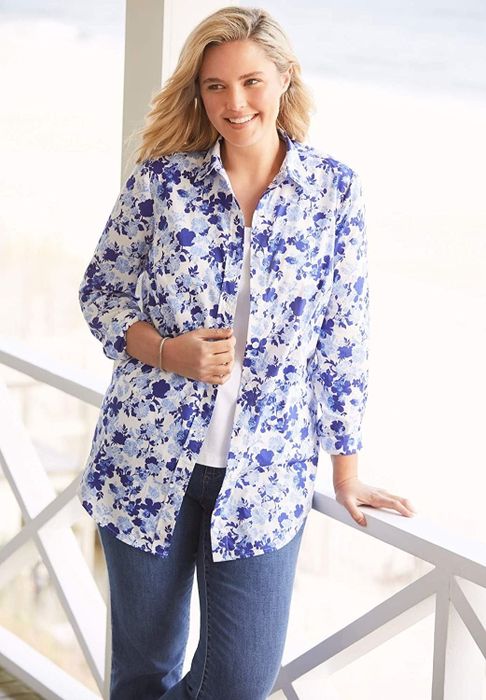 The model is wearing a button-down shirt featuring a blue floral print.